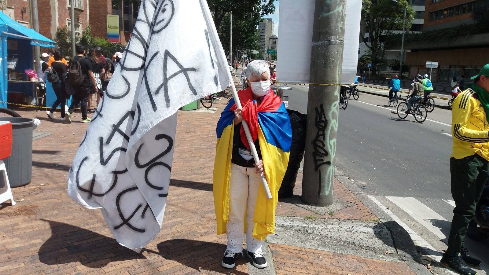 A protester wrapped in an inverted Colombian flag during the 2021 national strike in Medellín.